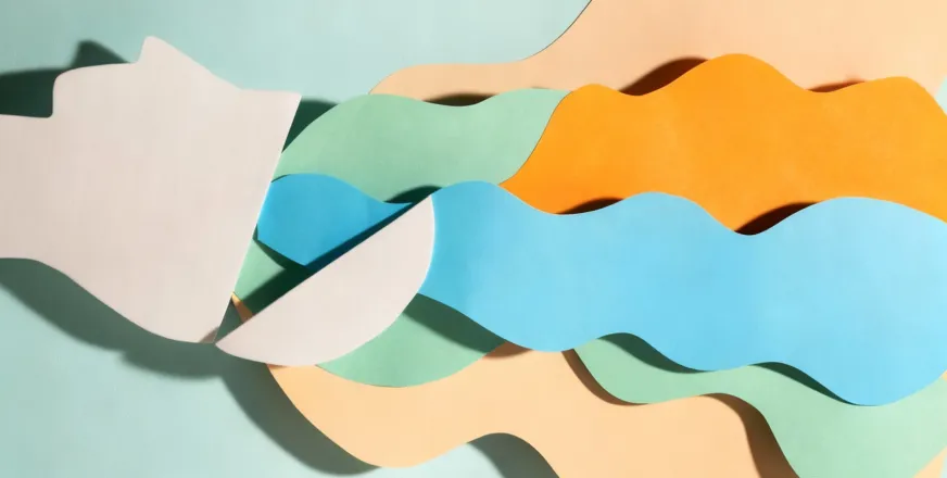 Paper cut collage artwork depicting colorful waves flowing from a silhouette, representing creative thought